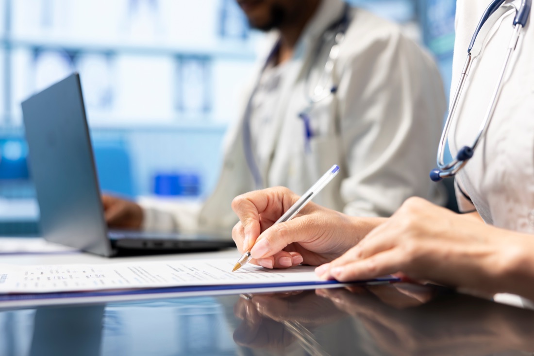 Doctor in a medical appraisal reviewing supporting information